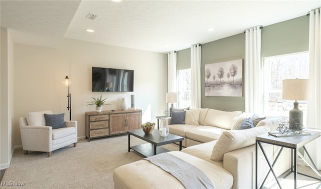 424 Honeycrisp Dr NE, Louisville, OH 44641 - living room featuring plenty of natural light, light colored carpet, recessed lighting, and baseboards