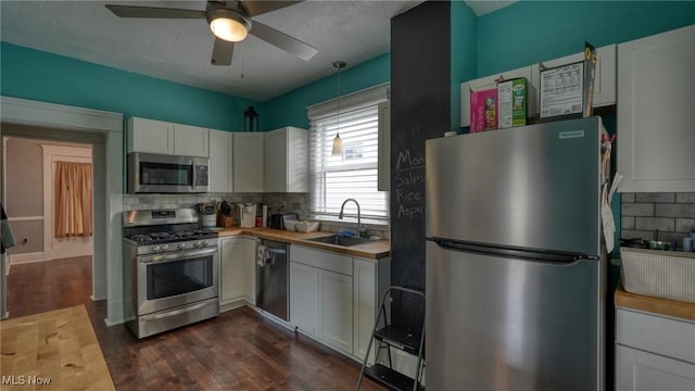 1200 Blaine Ave, Cambridge, OH 43725 - kitchen featuring appliances with stainless steel finishes, a sink, backsplash, and a ceiling fan