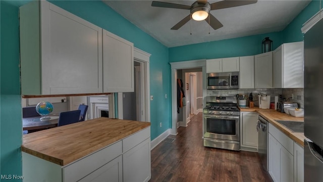 1200 Blaine Ave, Cambridge, OH 43725 - kitchen with appliances with stainless steel finishes, wood counters, backsplash, white cabinetry, and ceiling fan