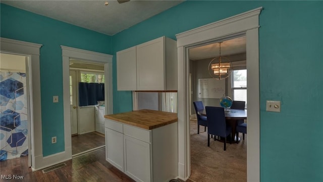1200 Blaine Ave, Cambridge, OH 43725 - kitchen with butcher block counters, a chandelier, white cabinets, and dark wood-type flooring