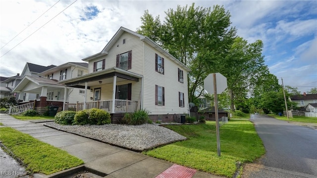 1200 Blaine Ave, Cambridge, OH 43725 - view of front of house featuring a porch, a front lawn, and central AC unit