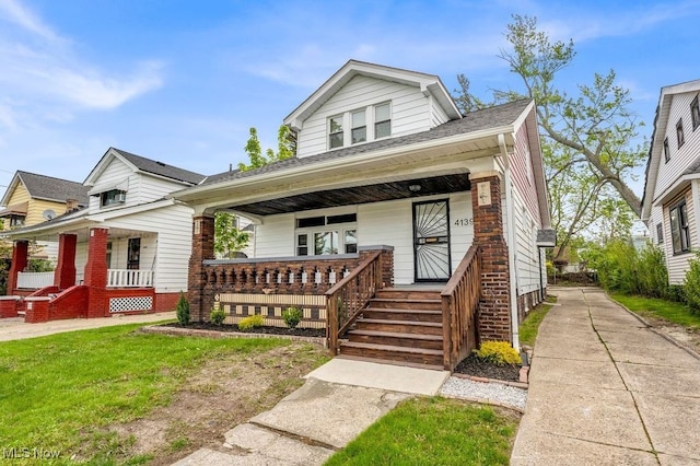 view of front of home featuring a porch and brick siding