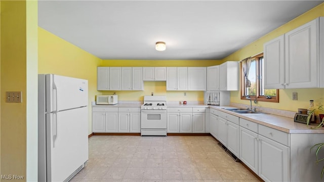 7116 Norwalk Rd, Medina, OH 44256 - kitchen with white appliances, a sink, light countertops, and white cabinetry