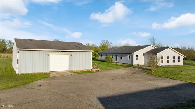 7116 Norwalk Rd, Medina, OH 44256 - view of property exterior featuring an outbuilding, a garage, driveway, and a lawn