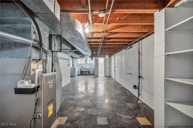 4422 Forest Hills Blvd, Parma, OH 44134 - basement featuring a sink, washer and dryer, concrete block wall, and heating unit