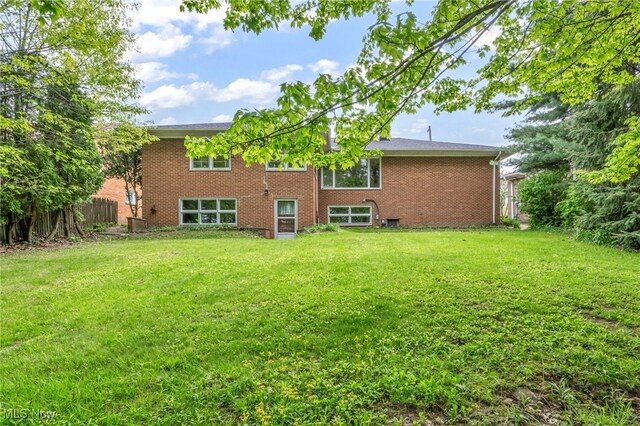 4422 Forest Hills Blvd, Parma, OH 44134 - back of property featuring a lawn and brick siding
