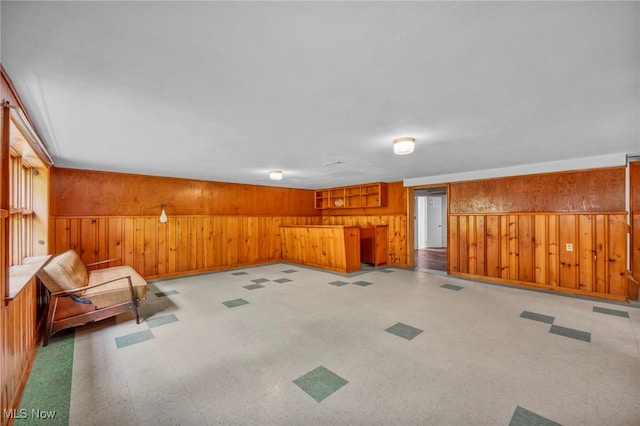 4422 Forest Hills Blvd, Parma, OH 44134 - unfurnished living room with wooden walls and tile patterned floors