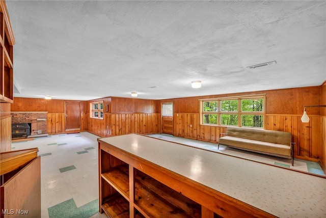4422 Forest Hills Blvd, Parma, OH 44134 - kitchen featuring wooden walls, tile patterned floors, a textured ceiling, and brown cabinets