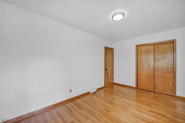 4422 Forest Hills Blvd, Parma, OH 44134 - unfurnished bedroom featuring baseboards, light wood-style floors, and a closet