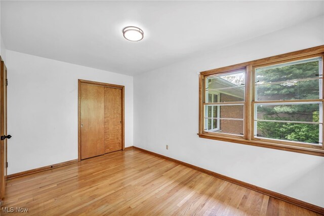 4422 Forest Hills Blvd, Parma, OH 44134 - unfurnished bedroom with baseboards, light wood-style flooring, and a closet