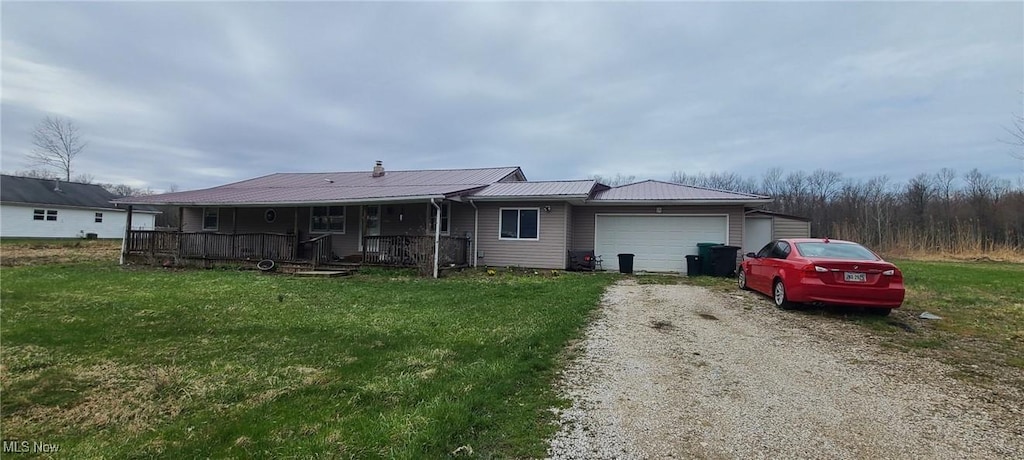 4895 Hawley Dr, Geneva-On-The-Lake, OH 44041 - view of front of home featuring an attached garage, driveway, a front yard, and a porch