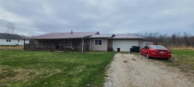 4895 Hawley Dr, Geneva-On-The-Lake, OH 44041 - view of front of home featuring an attached garage, driveway, a front yard, and a porch