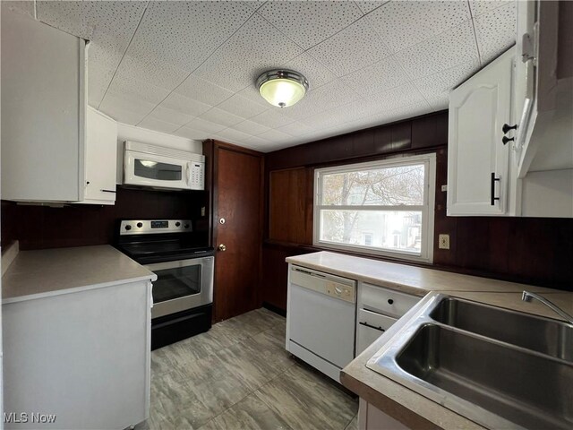 286 W Grace St, Bedford, OH 44146 - kitchen featuring white appliances, a sink, white cabinets, light countertops, and a paneled ceiling