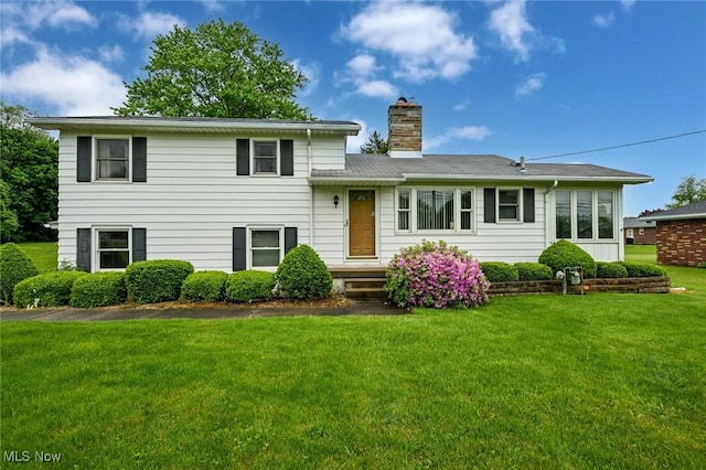 1883 Massillon Rd, Akron, OH 44312 - tri-level home with a front lawn and a chimney