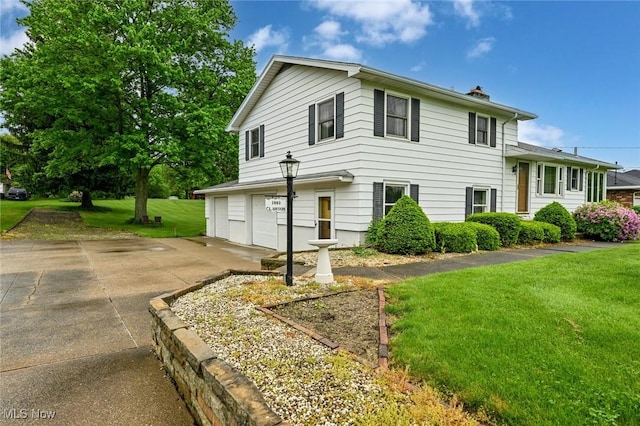 1883 Massillon Rd, Akron, OH 44312 - view of front of home with a garage, driveway, a chimney, and a front yard