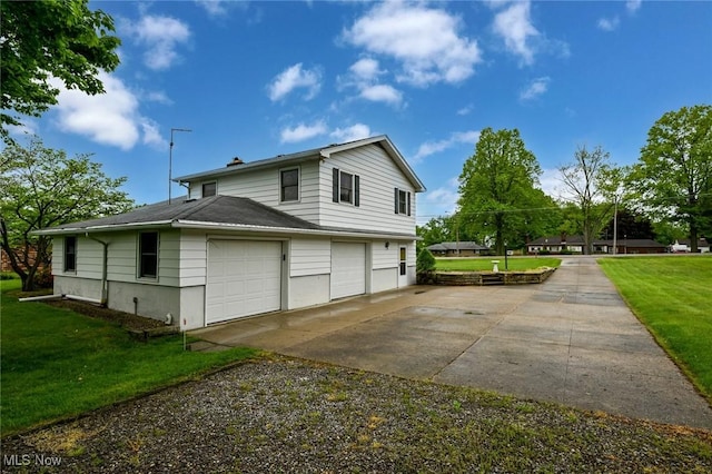 1883 Massillon Rd, Akron, OH 44312 - view of property exterior featuring a lawn, concrete driveway, a garage, and a chimney