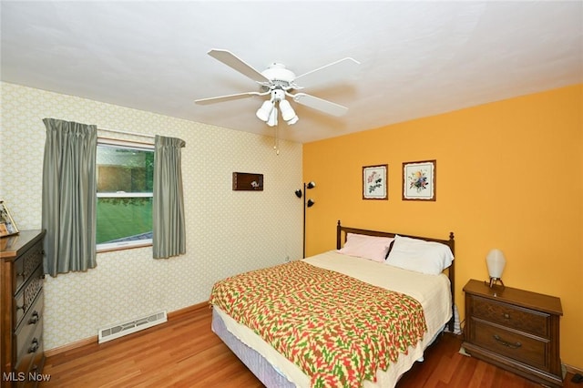 1883 Massillon Rd, Akron, OH 44312 - bedroom featuring wood finished floors, baseboards, ceiling fan, and wallpapered walls