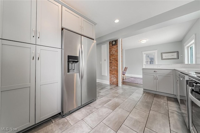 1303 W 115th St, Cleveland, OH 44102 - kitchen with appliances with stainless steel finishes, light countertops, gray cabinetry, recessed lighting, and light tile patterned flooring