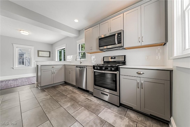1303 W 115th St, Cleveland, OH 44102 - kitchen with appliances with stainless steel finishes, gray cabinets, light countertops, and recessed lighting