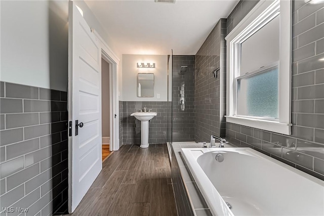 1303 W 115th St, Cleveland, OH 44102 - full bath with tile walls, a garden tub, wood finished floors, and a shower stall