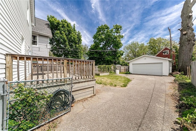 1303 W 115th St, Cleveland, OH 44102 - view of yard featuring an outdoor structure, a garage, fence, and a deck