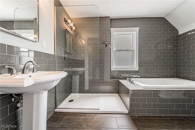 1303 W 115th St, Cleveland, OH 44102 - full bath with tile walls, wood finished floors, and a bath