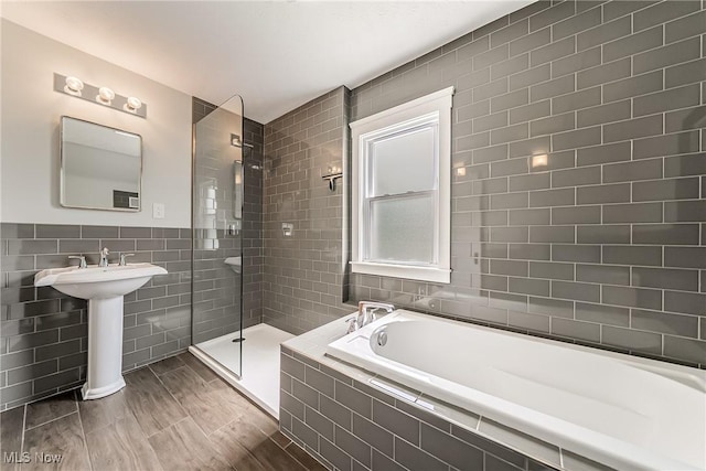 1303 W 115th St, Cleveland, OH 44102 - full bath featuring tile walls, a bath, walk in shower, and a sink