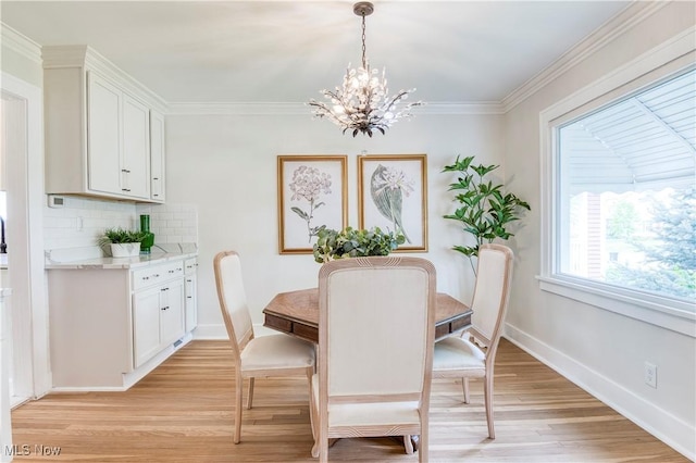 2332 Allison Rd, University Heights, OH 44118 - dining space featuring a chandelier, light wood-style flooring, baseboards, and ornamental molding