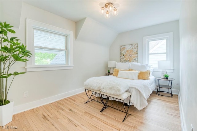 2332 Allison Rd, University Heights, OH 44118 - bedroom with multiple windows, wood finished floors, and baseboards