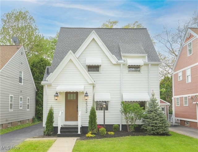 2332 Allison Rd, University Heights, OH 44118 - view of front facade featuring entry steps, roof with shingles, and a front lawn