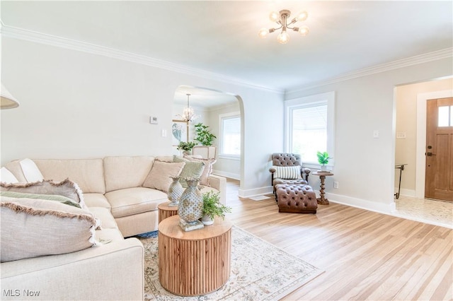 2332 Allison Rd, University Heights, OH 44118 - living room featuring arched walkways, wood finished floors, a chandelier, crown molding, and baseboards