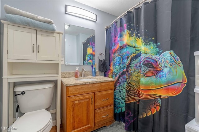 bathroom featuring toilet and vanity