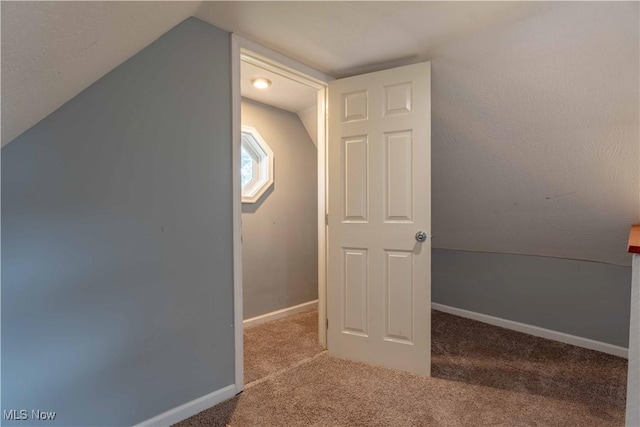 bonus room featuring carpet floors, lofted ceiling, and baseboards