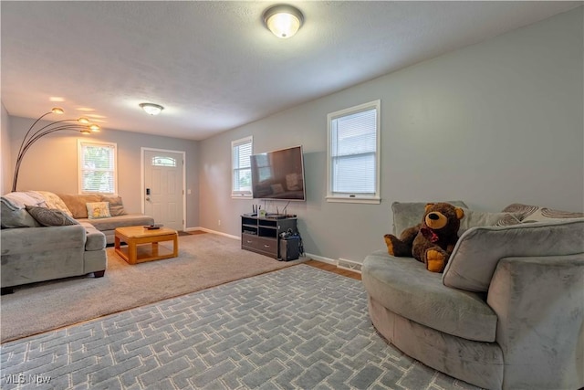 living area with carpet and baseboards