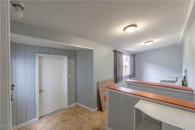 kitchen with stone finish flooring and baseboards