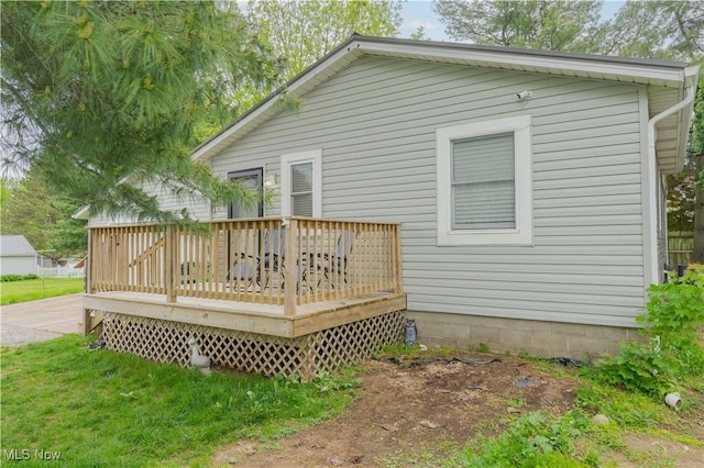 rear view of property featuring a wooden deck