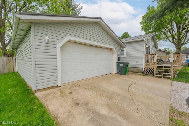 detached garage featuring fence