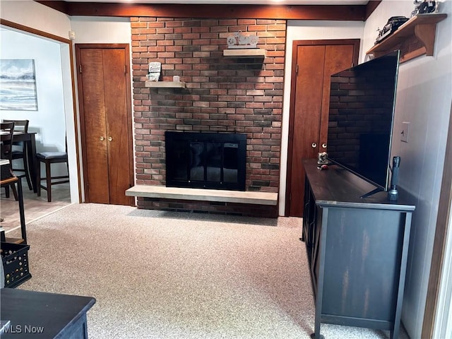 living room featuring a brick fireplace and light colored carpet