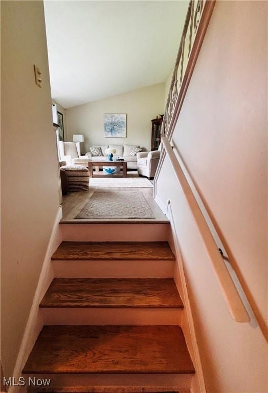 staircase featuring lofted ceiling