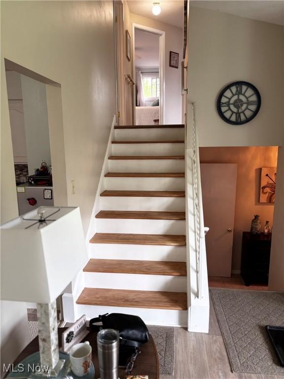 stairway with wood finished floors