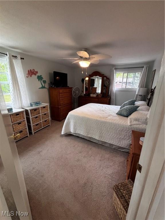 carpeted bedroom with ceiling fan