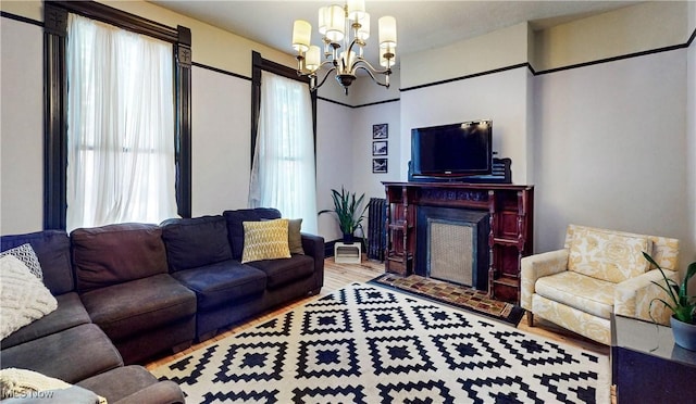 2963 Scranton Rd, Cleveland, OH 44113 - living room with a chandelier, wood finished floors, and a fireplace with flush hearth