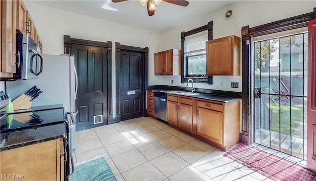 2963 Scranton Rd, Cleveland, OH 44113 - kitchen featuring appliances with stainless steel finishes, a sink, ceiling fan, light tile patterned floors, and brown cabinetry