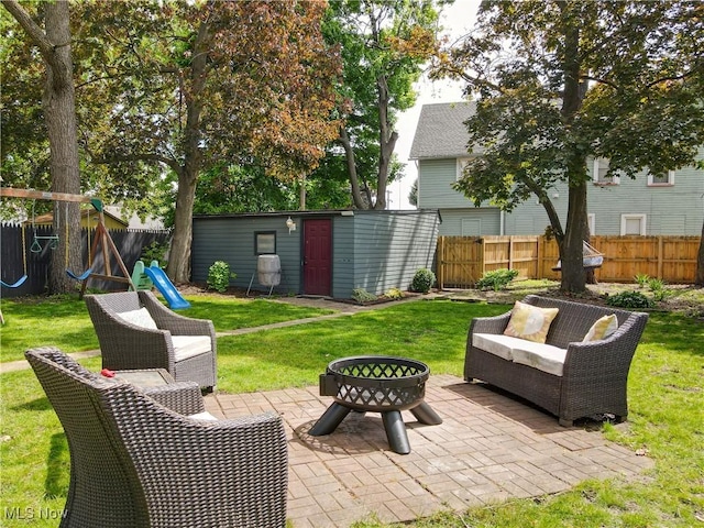 2963 Scranton Rd, Cleveland, OH 44113 - view of patio / terrace with a fire pit, a playground, an outdoor structure, and a storage unit