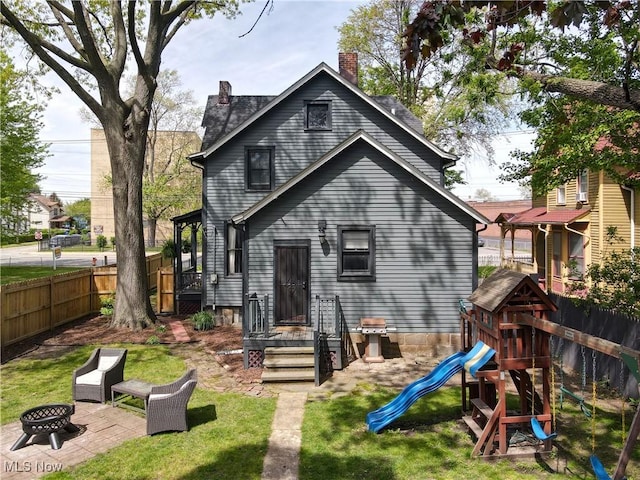 2963 Scranton Rd, Cleveland, OH 44113 - back of house featuring a playground, a chimney, and an outdoor fire pit