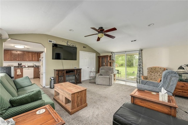 living room featuring lofted ceiling, ceiling fan, light colored carpet, and arched walkways