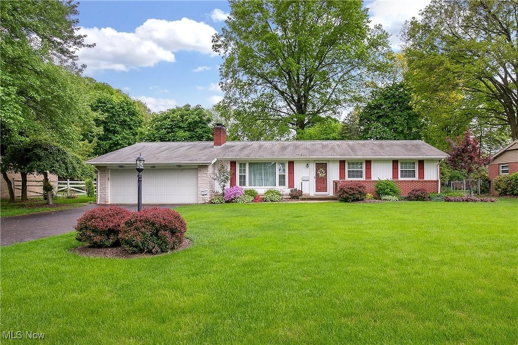 2406 Bevington St NW, Canton, OH 44709 - single story home featuring an attached garage, a chimney, driveway, and brick siding