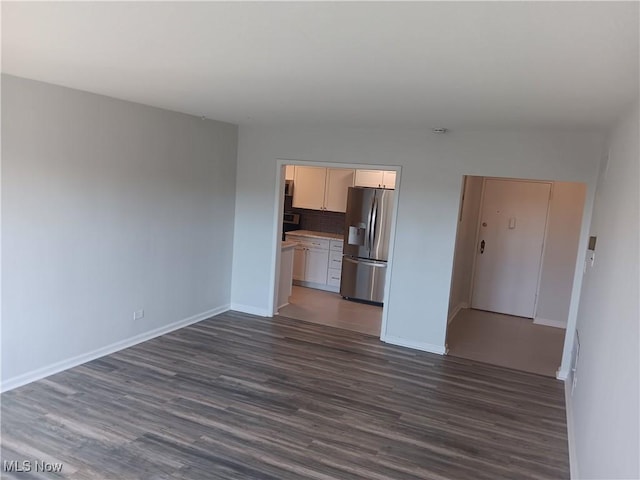 13800 Fairhill Rd Unit 515, Shaker Heights, OH 44120 - unfurnished living room with dark wood-style floors and baseboards