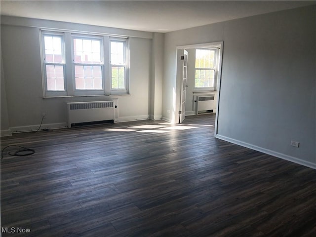 13800 Fairhill Rd Unit 515, Shaker Heights, OH 44120 - spare room featuring radiator heating unit, dark wood-style flooring, and baseboards