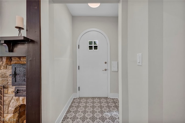 17617 Lomond Blvd, Shaker Heights, OH 44120 - doorway with baseboards, arched walkways, and tile patterned floors